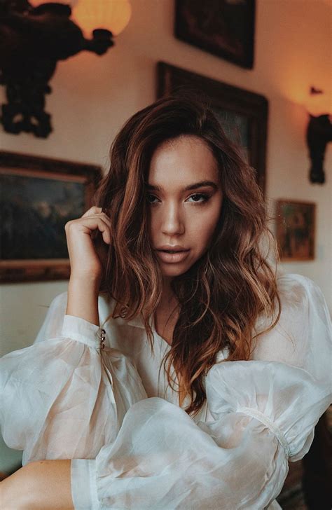 Alexis Ren poses topless in the shower .